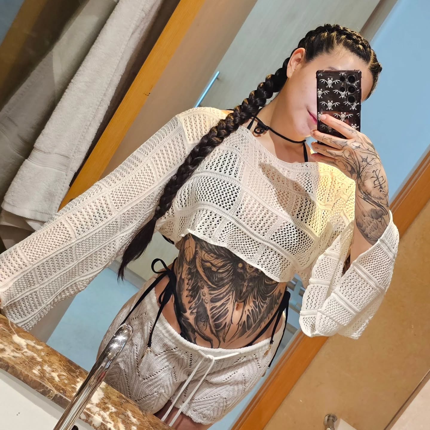 charlotte_germanotta_ taking mirror selfie wearing white crochet crop top in bathroom