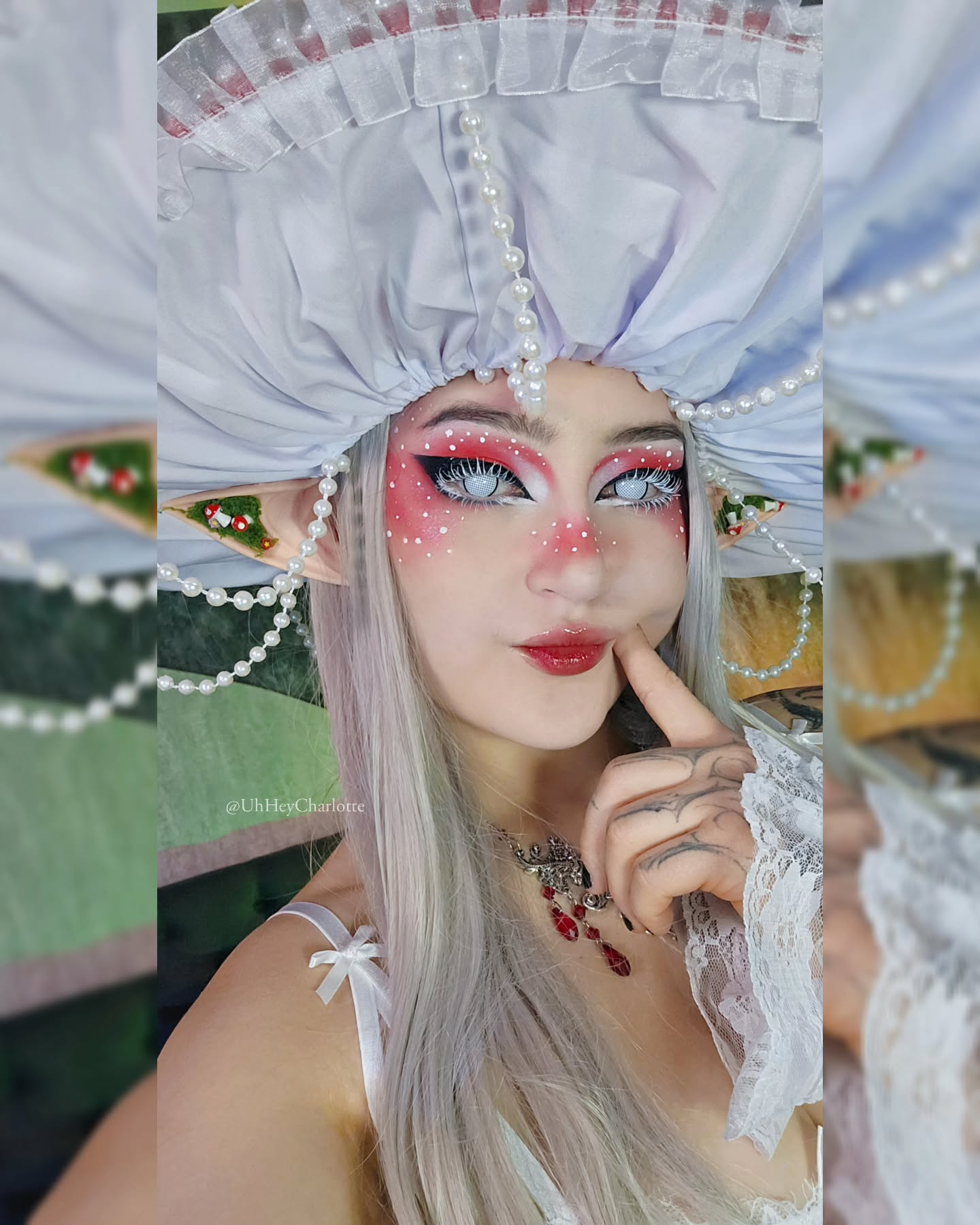 charlotte_germanotta_ posing with finger on cheek wearing white mushroom hat with pearls