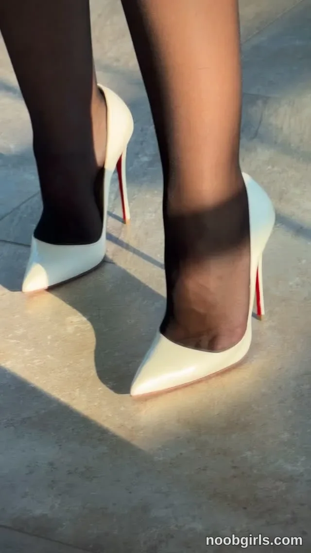 chloe_ri wearing black tights on a paved concrete or stone surface
