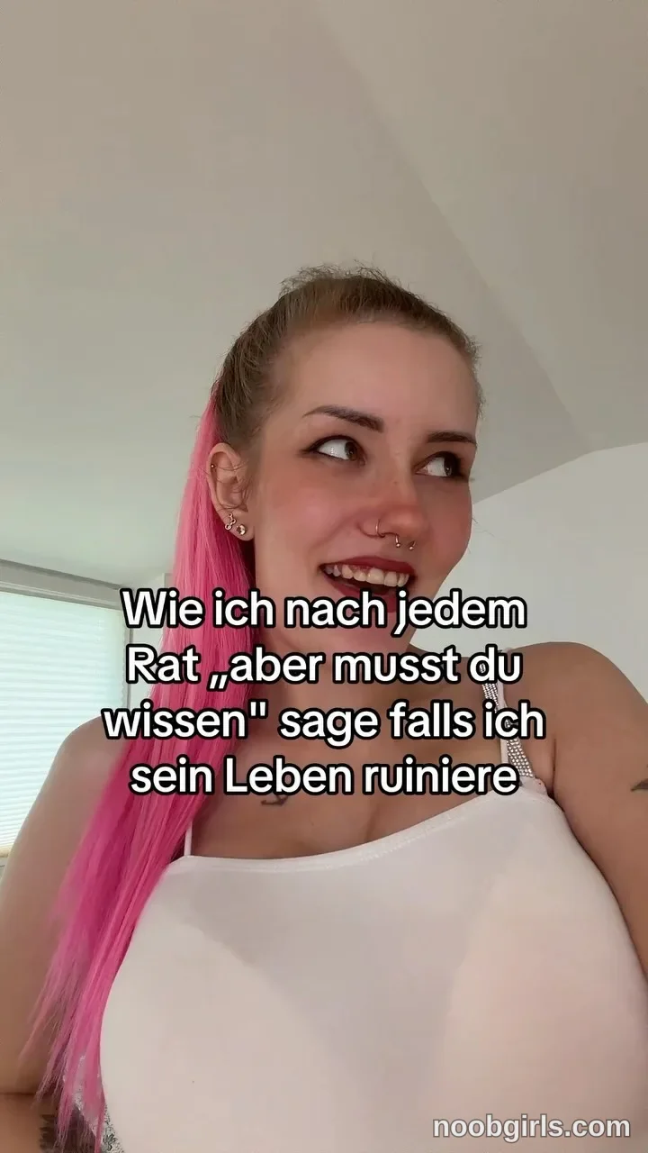 ClaraStylezZ looking to the side wearing white sleeveless top in residential room