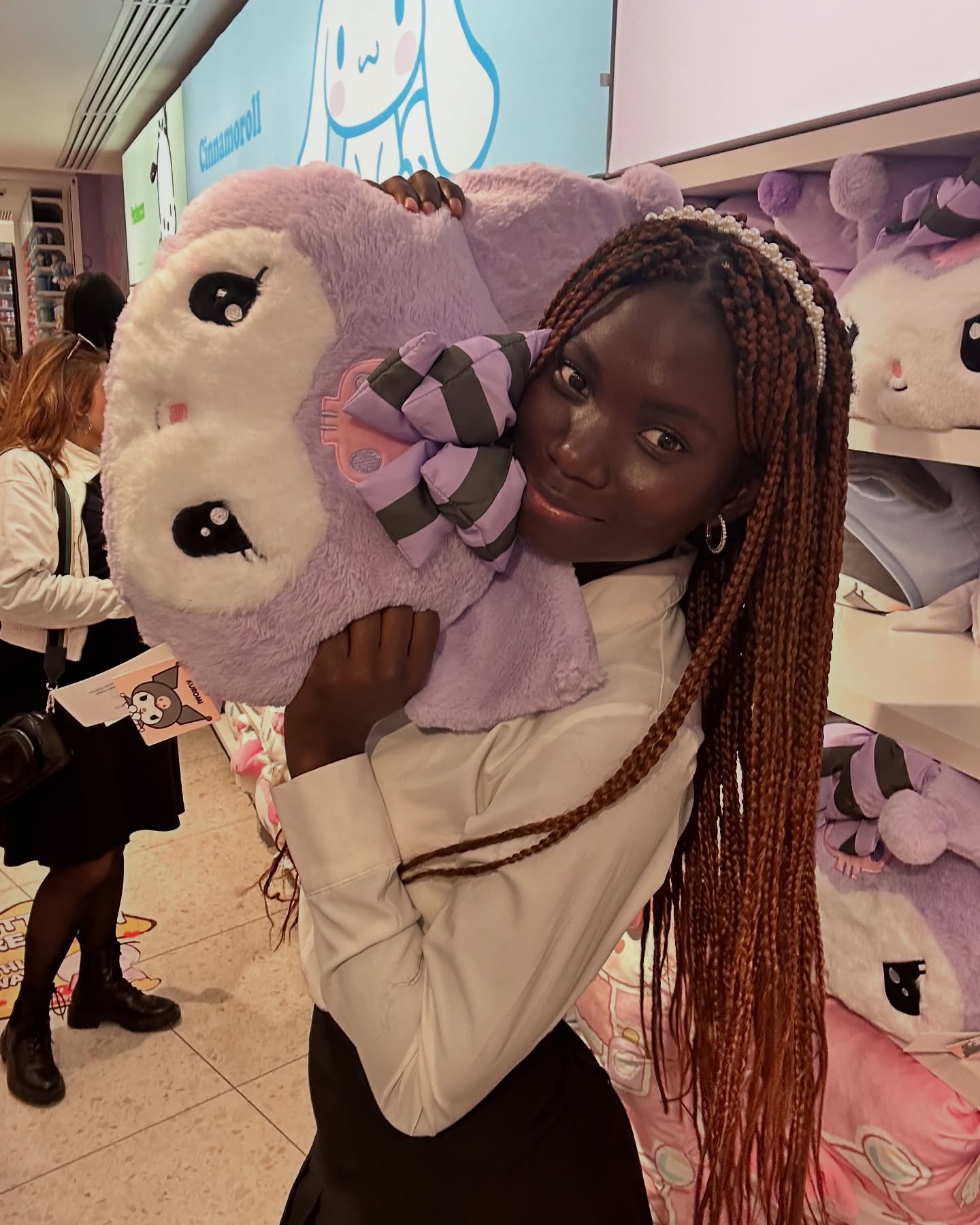 conymegan holding a plush toy wearing white button-up shirt in toy store