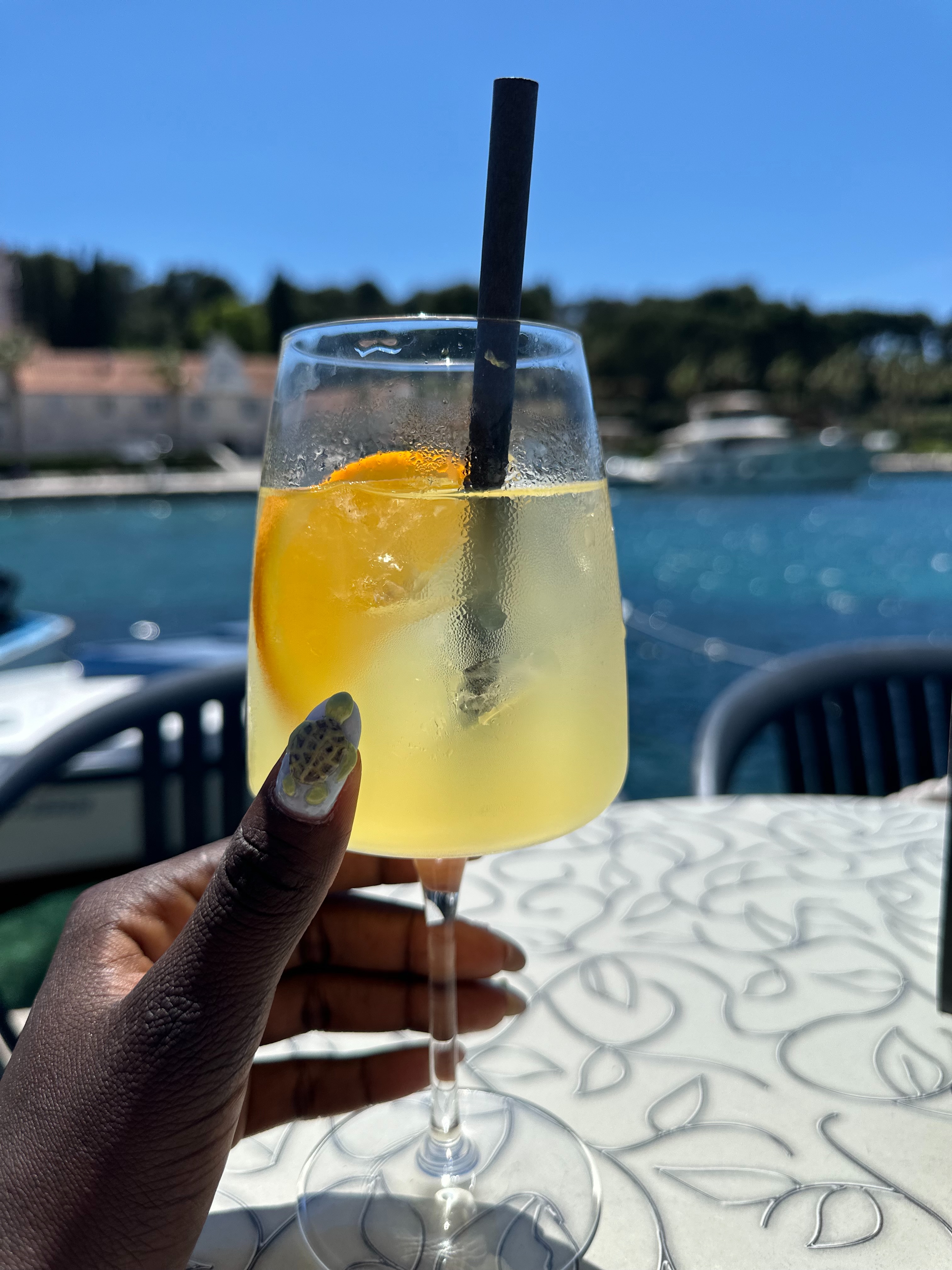 conymegan holding a glass in waterfront terrace