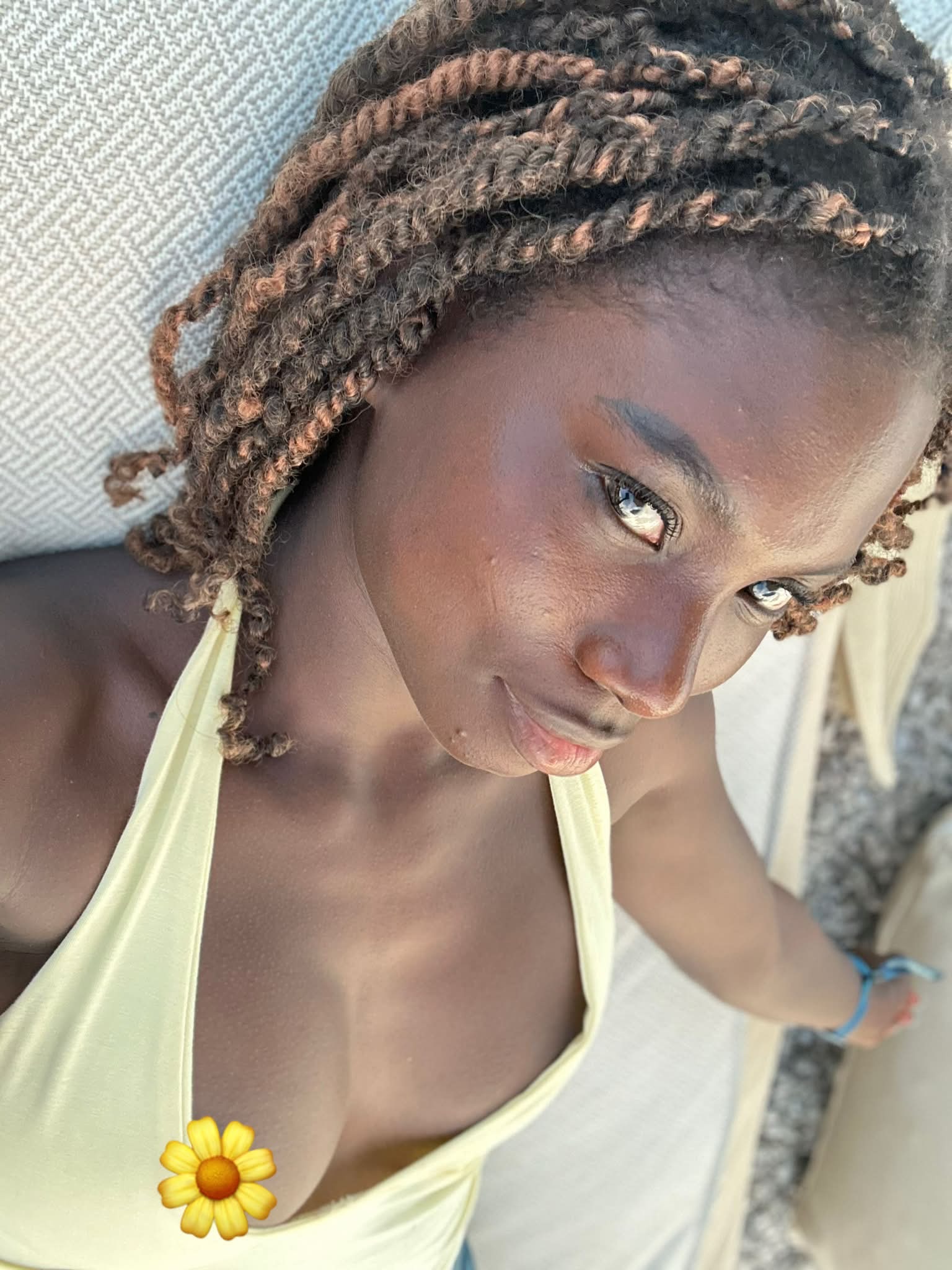 conymegan reclining wearing yellow halter top in lounge chair