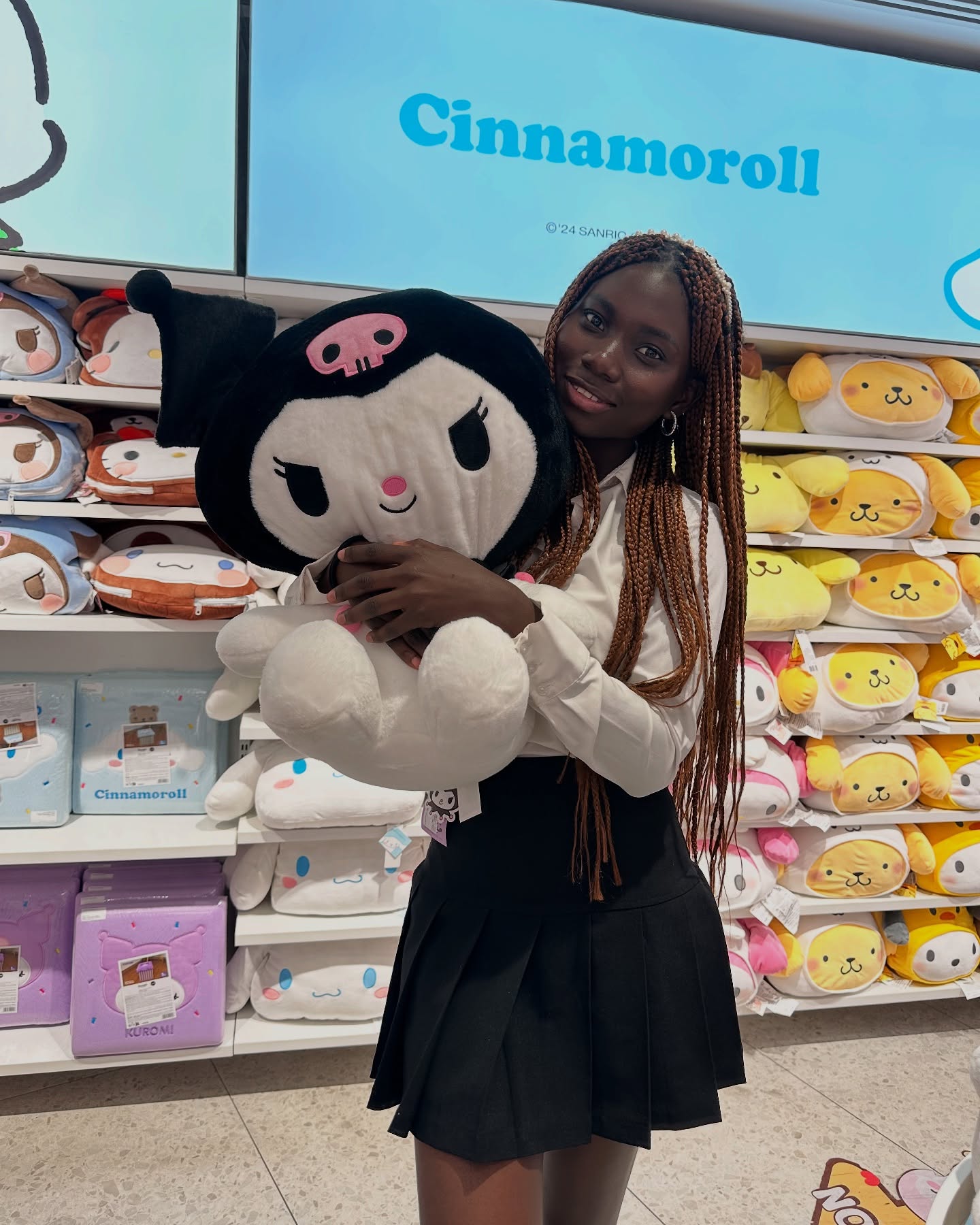 conymegan holding a large plush toy wearing white collared shirt in toy store