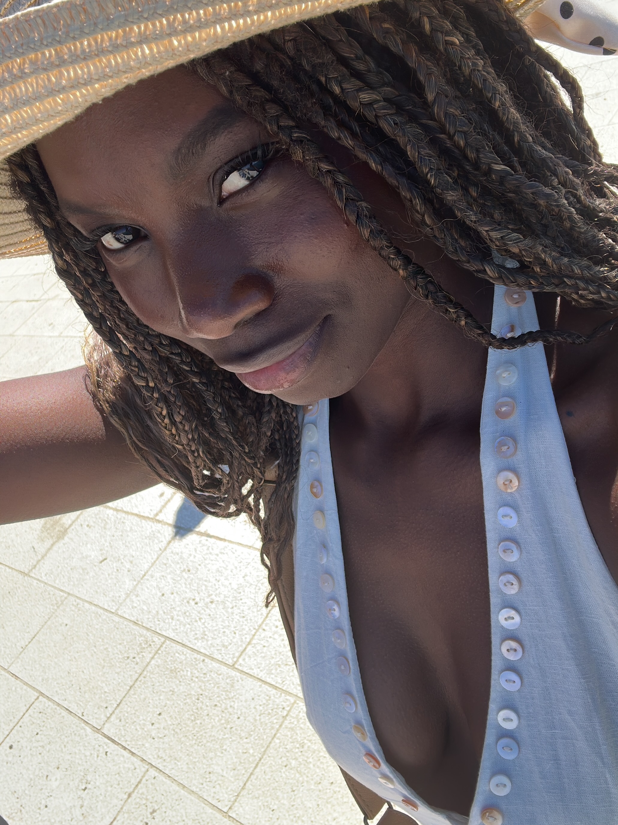 conymegan wearing straw hat in tiled patio