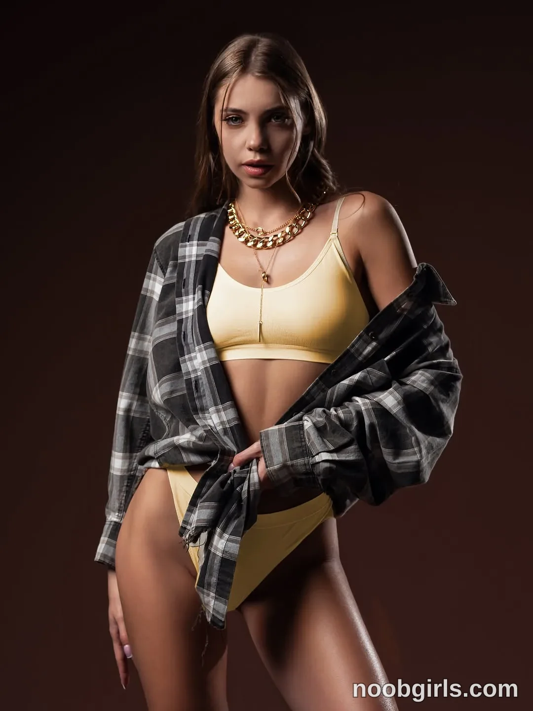 CoverM Standing facing the camera wearing Pale yellow bra-style top with thin straps