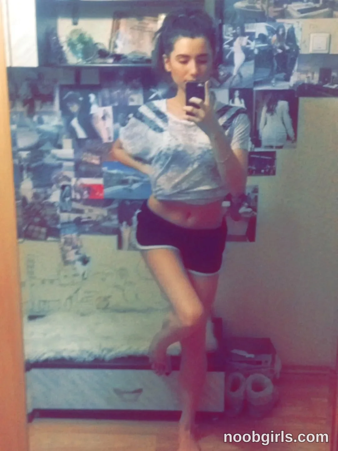 crystalnut taking a mirror selfie wearing grey t-shirt in bedroom