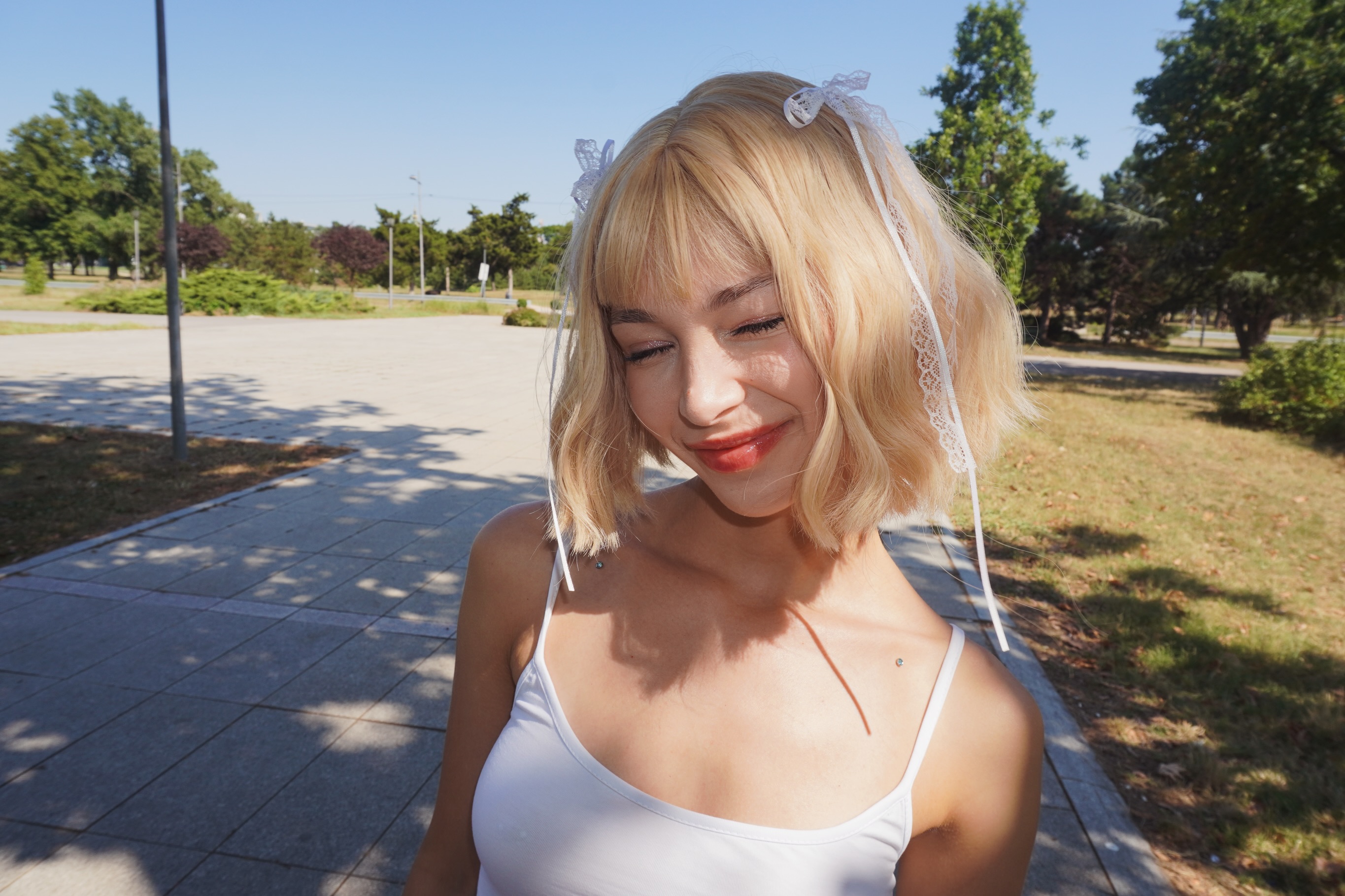 cutieeeeva wearing white camisole in park