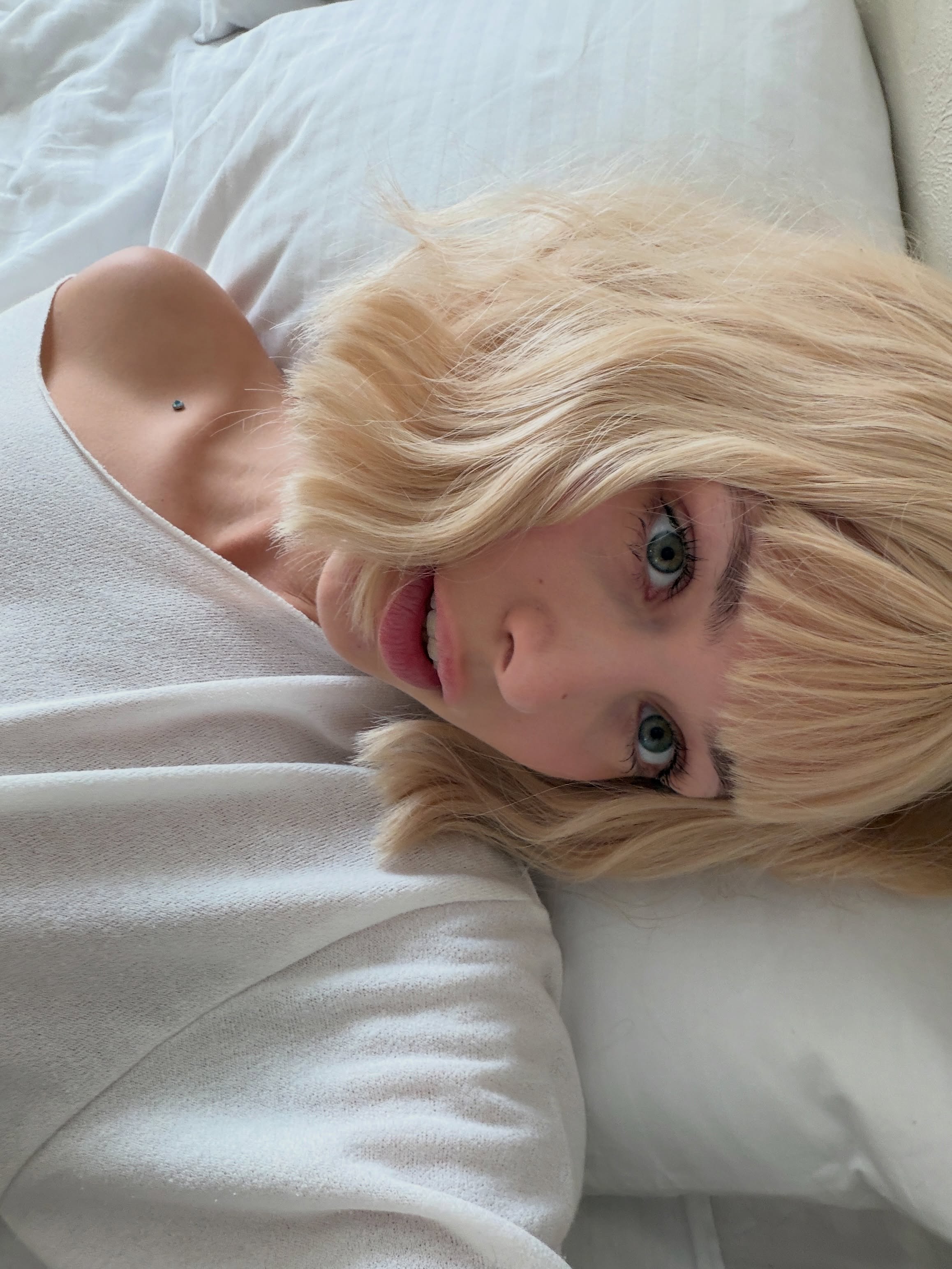 cutieeeeva lying on bed wearing white top in bed