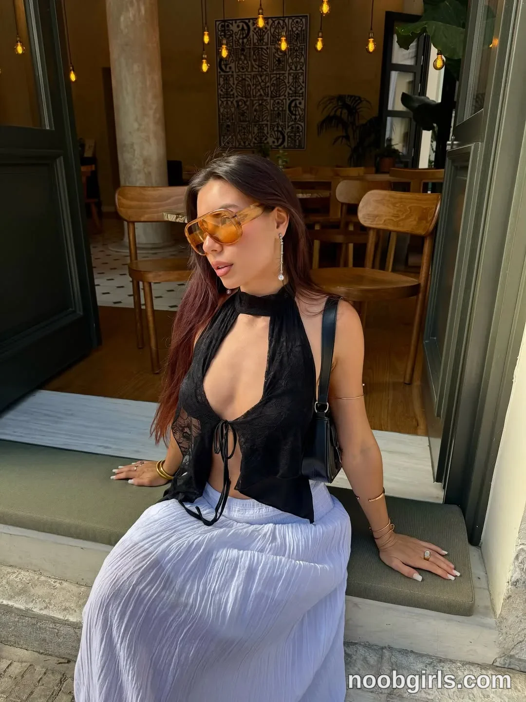 deniseglows Sitting on the doorway threshold with both hands resting beside her