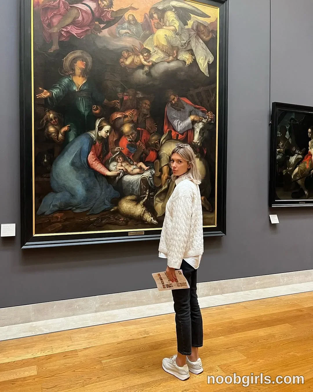 dreamana Standing beside a large painting wearing White quilted jacket in art gallery in Paris, France