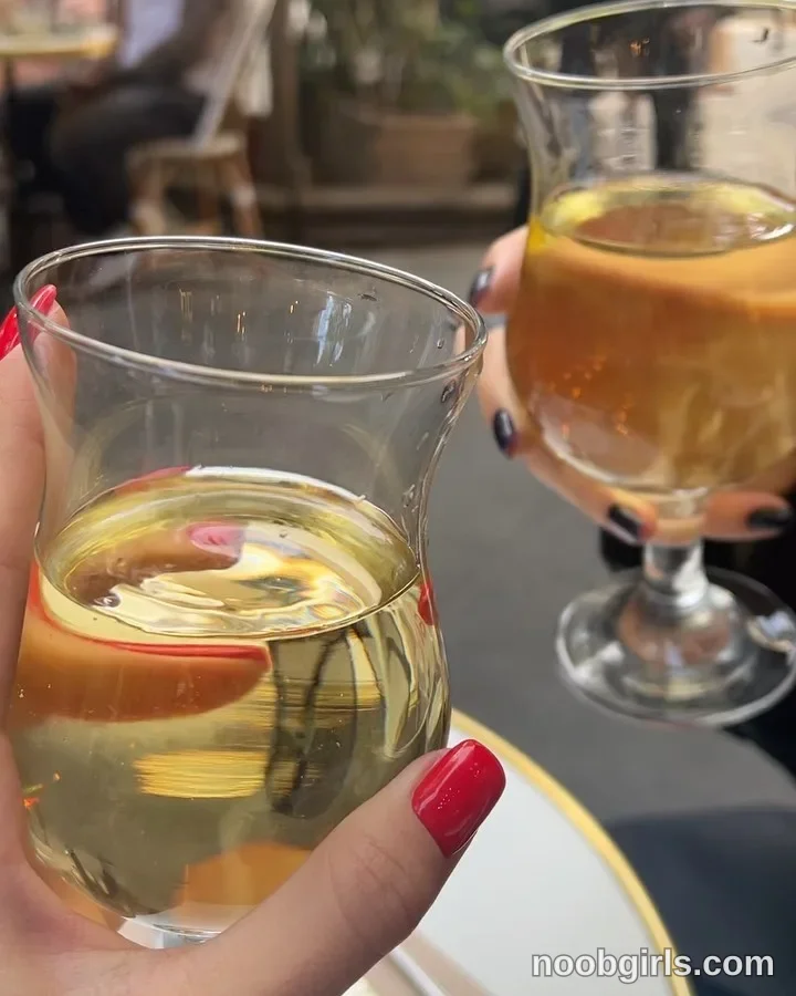 dreamana Two people are each holding a glass near the other glass; the foreground hand has red-painted nails in Seating area