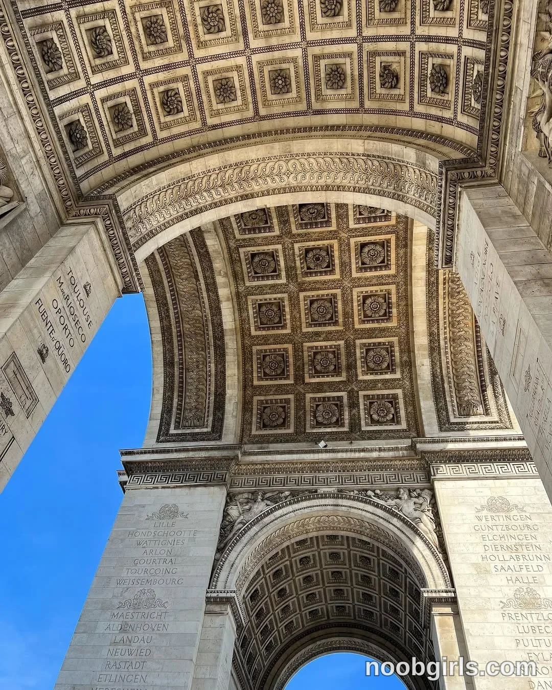 dreamana No woman or other person is visible. in beneath a monumental stone triumphal arch in Paris, France