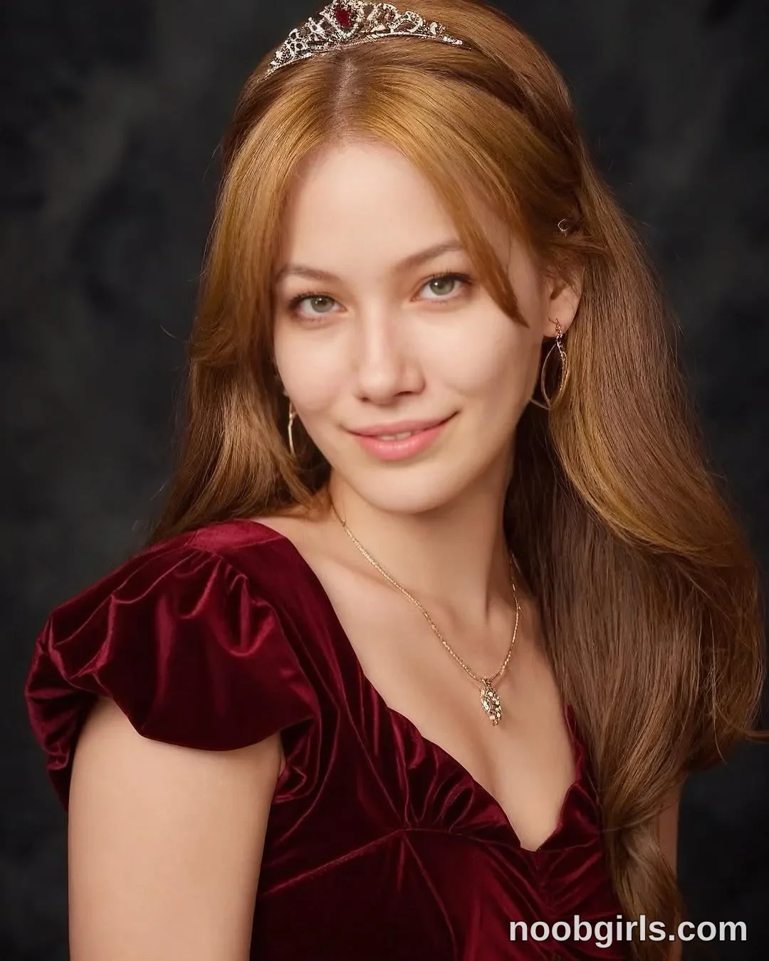 Eff Posing with her torso angled wearing Burgundy velvet dress with short puff sleeves and a low neckline