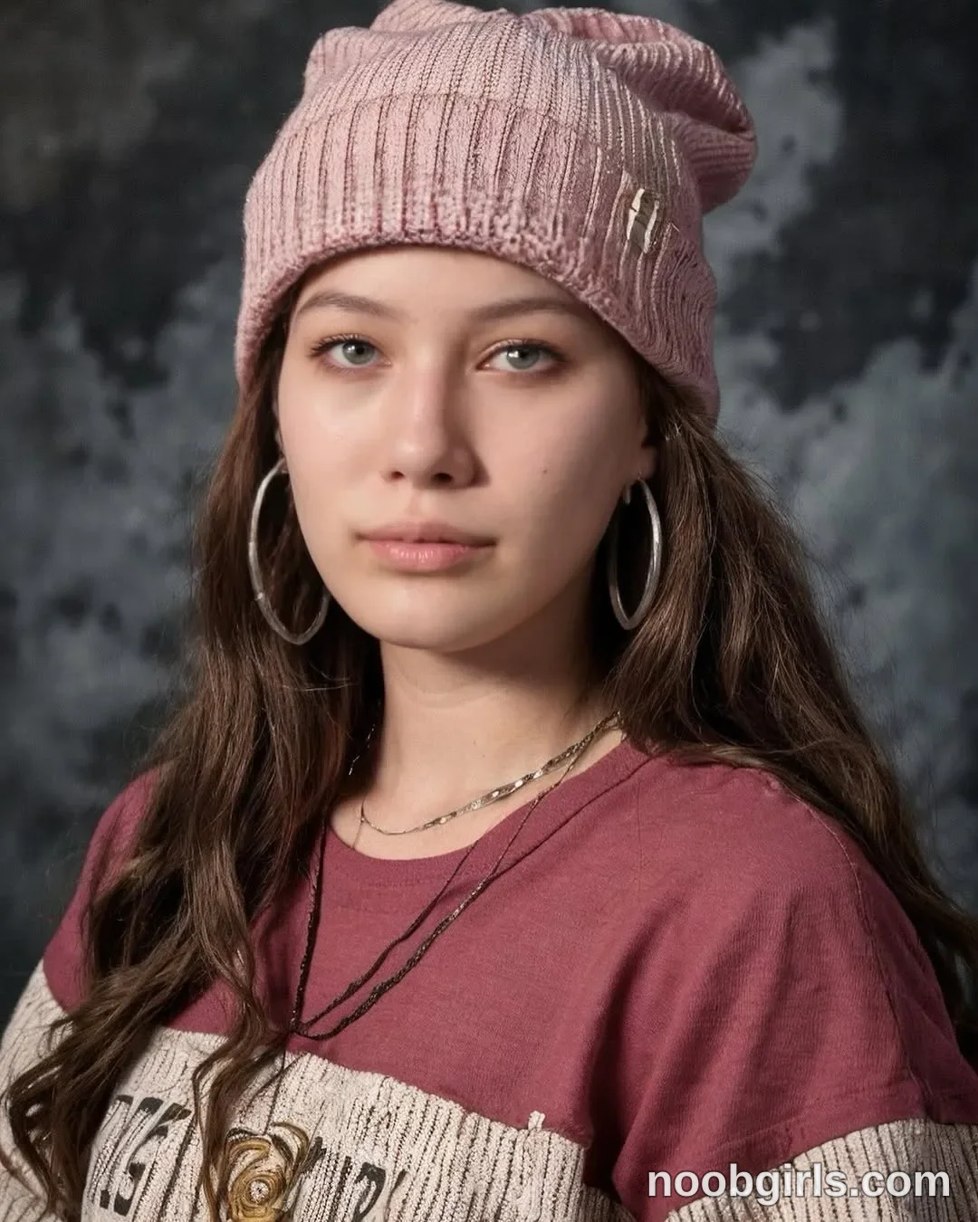 Eff Facing the camera with her head turned slightly wearing Pink ribbed knit beanie with a small metallic emblem