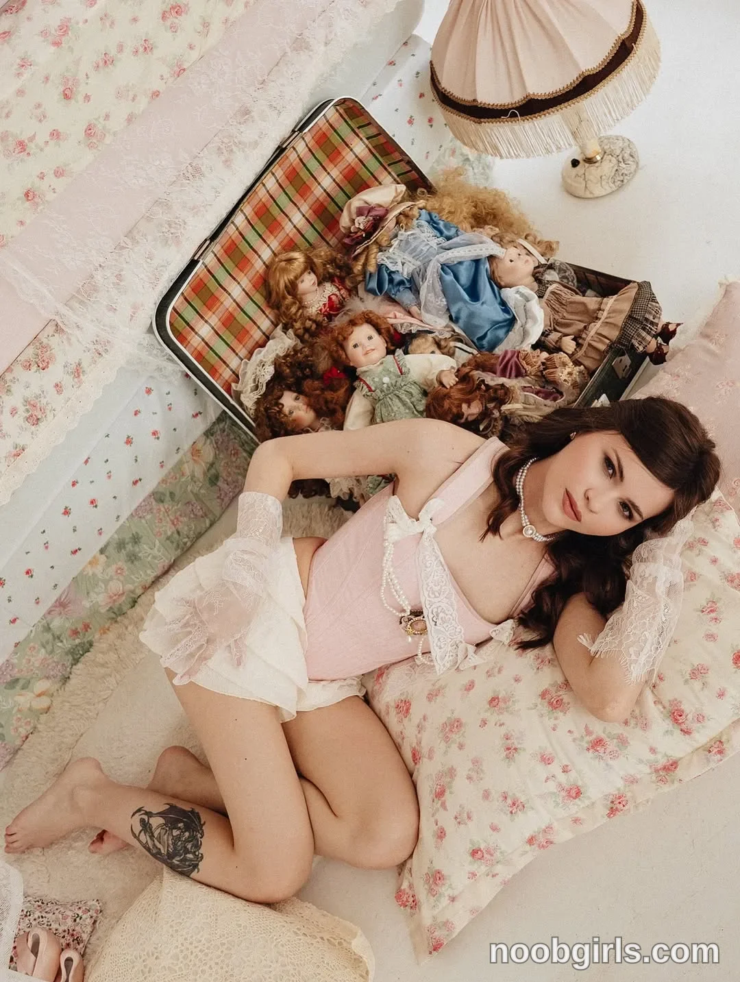 Molly reclining on a floral-covered padded surface with her legs bent