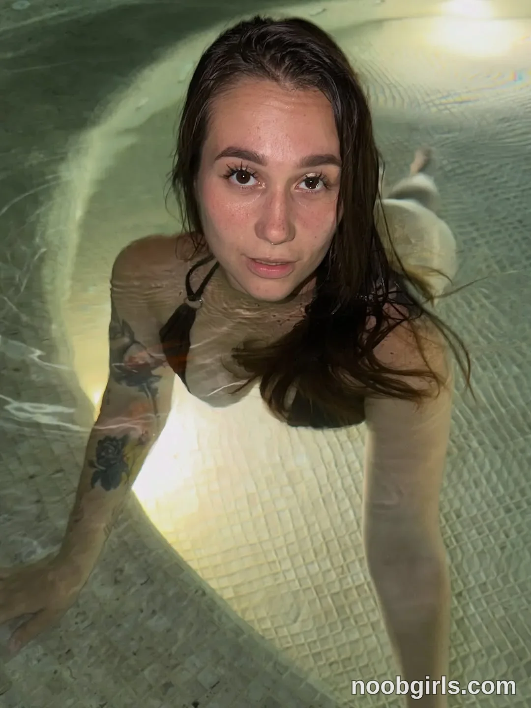 Lixie lixiesucks submerged in pool water wearing dark brown or black halter-style bikini top in swimming pool or hot tub
