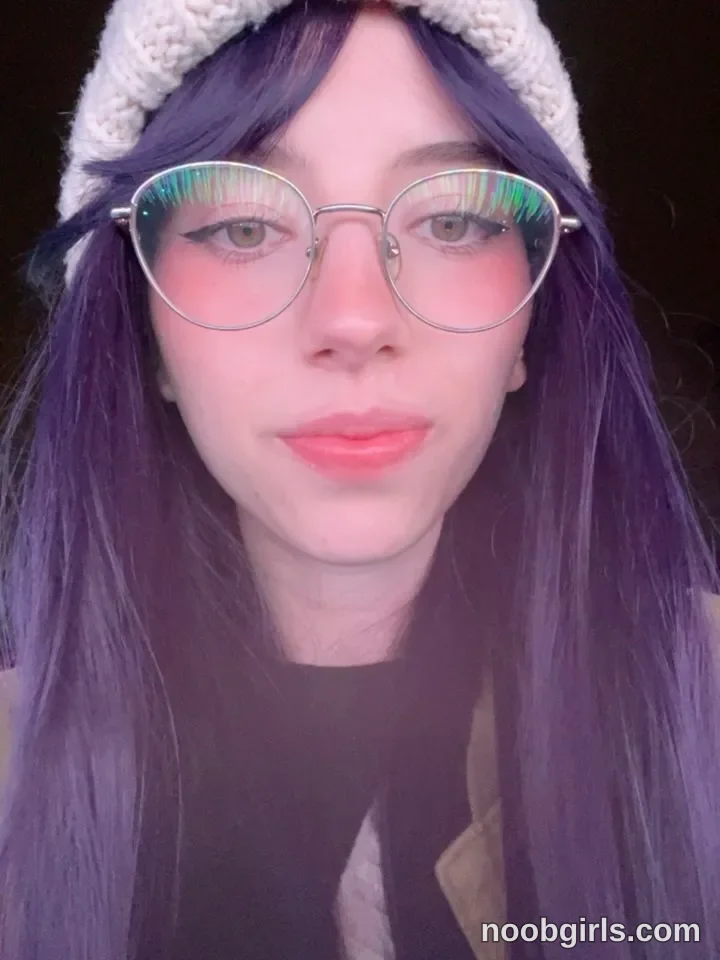 Jelly Facing the camera wearing White knitted hat in or outdoor cannot be determined; dark background