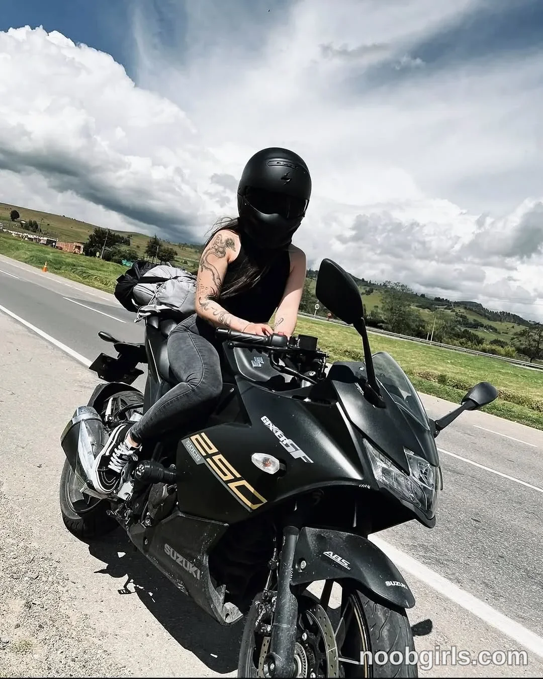 lau__1 Sitting astride the motorcycle wearing Black full-face motorcycle helmet with a dark visor