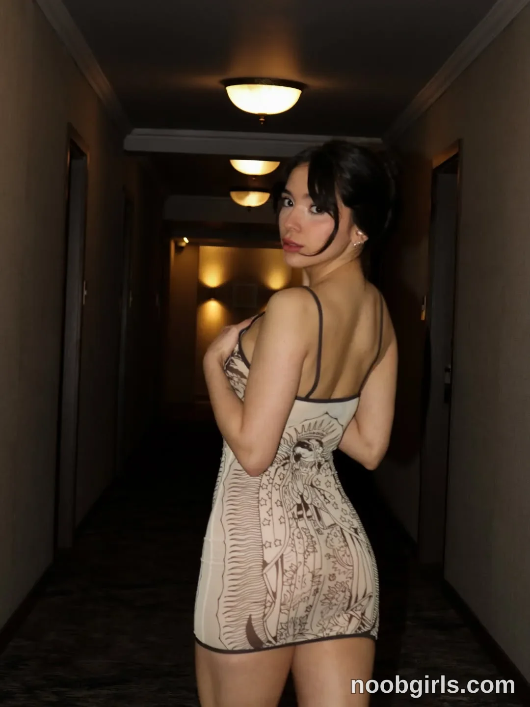 mariannacruzz Standing with her back partly toward the camera