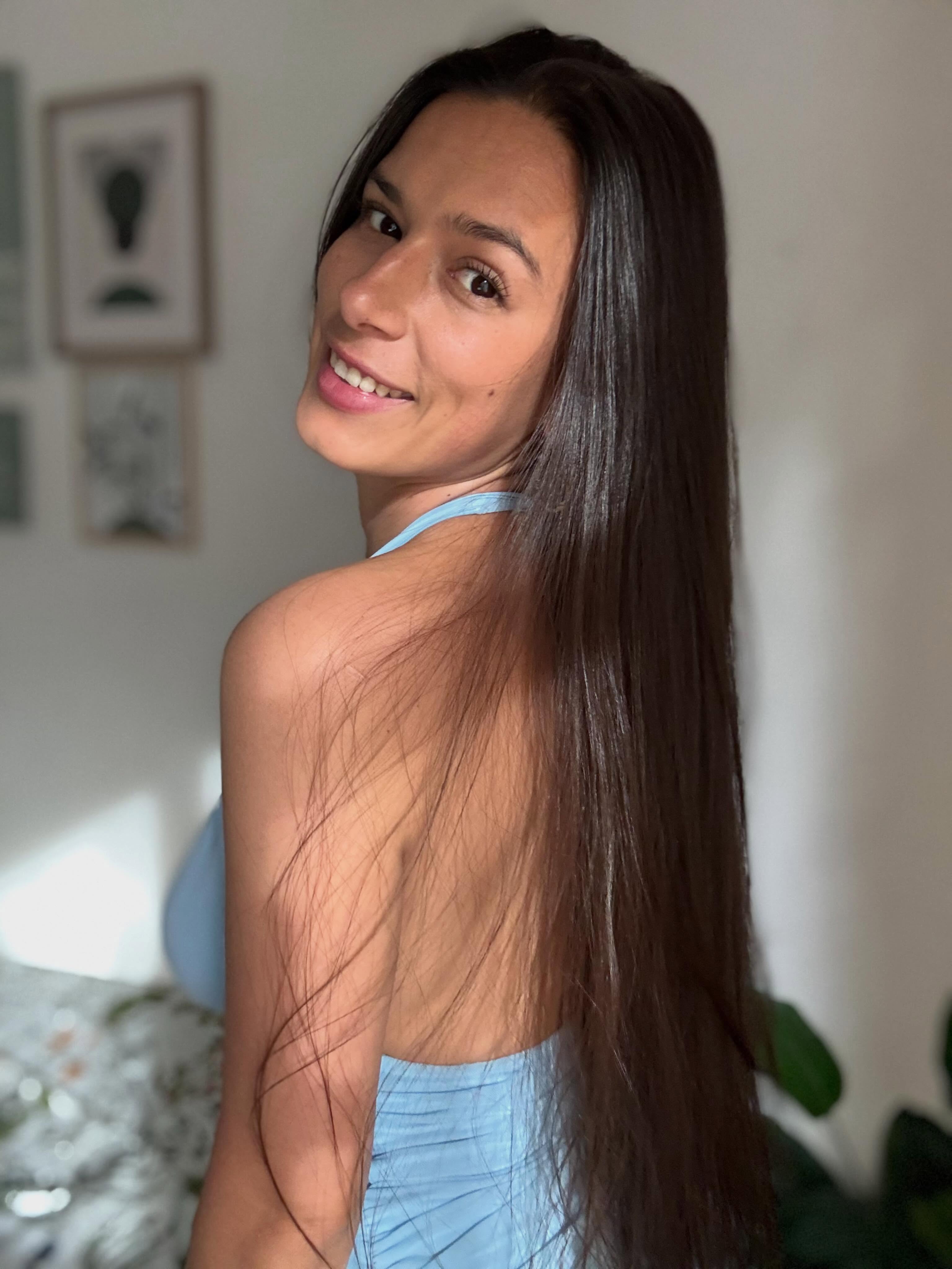 ohanna turning torso wearing light blue backless halter top or dress in room