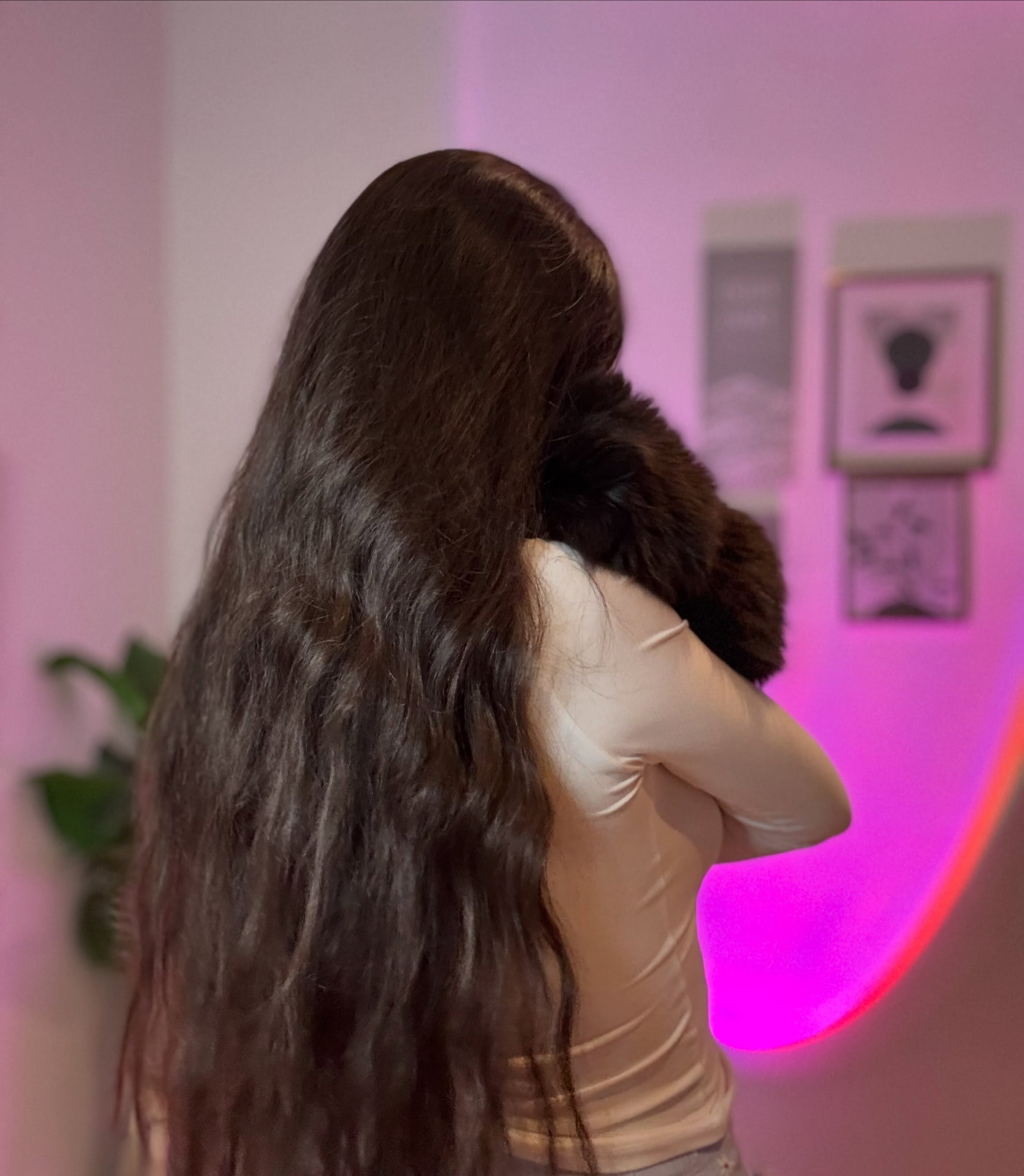 ohanna facing away from the camera wearing light beige or off-white long-sleeved top in room