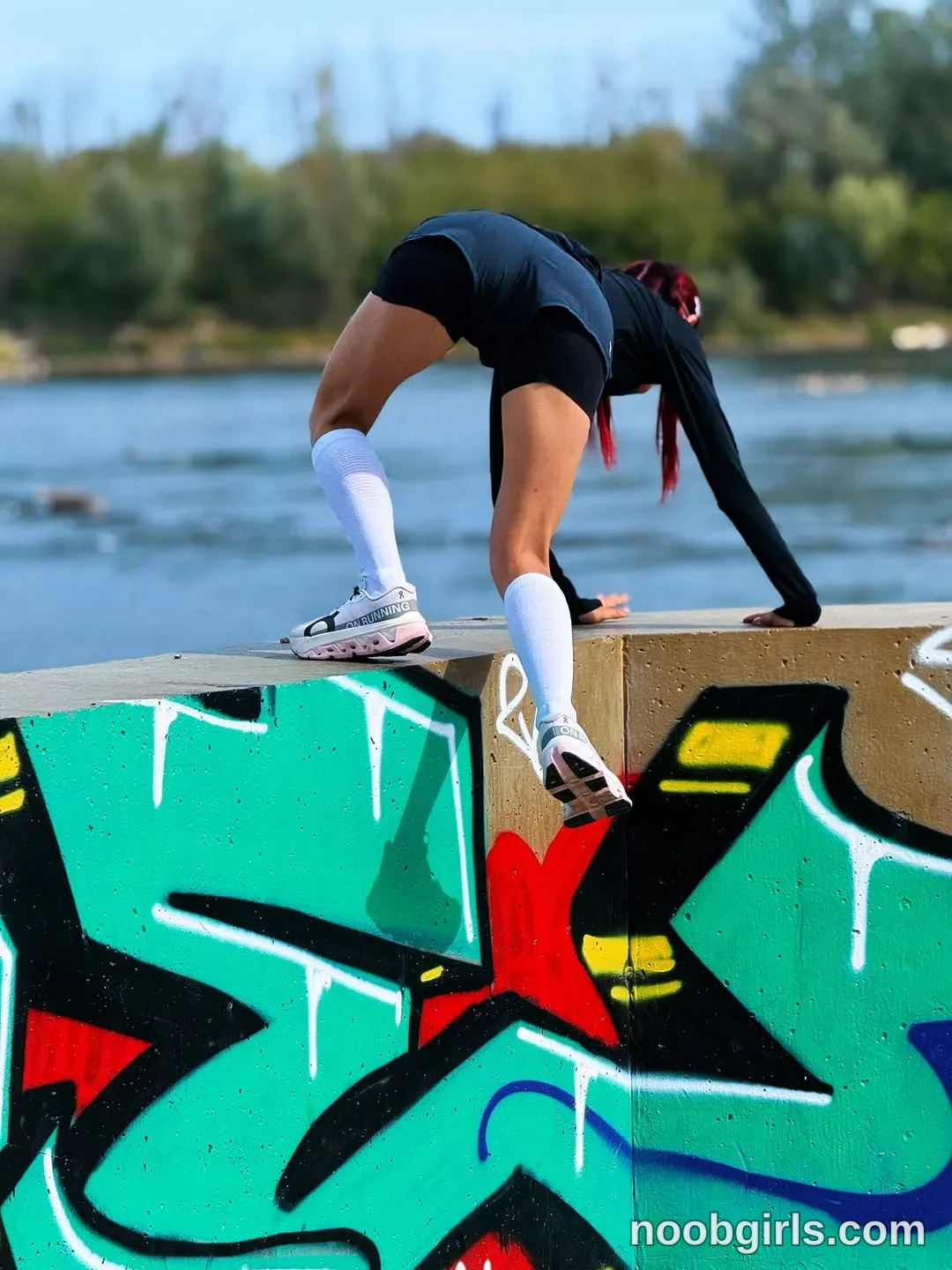 evaoopsy Bent forward with both hands on the top of the wall wearing Black long-sleeved top