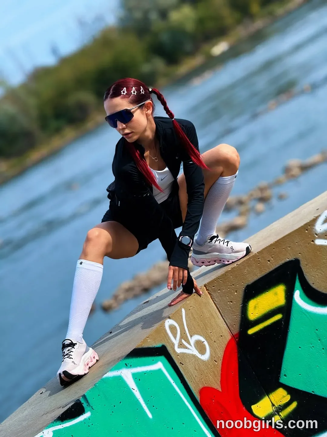 evaoopsy crouching with her feet apart on the sloping concrete wearing black long-sleeved jacket