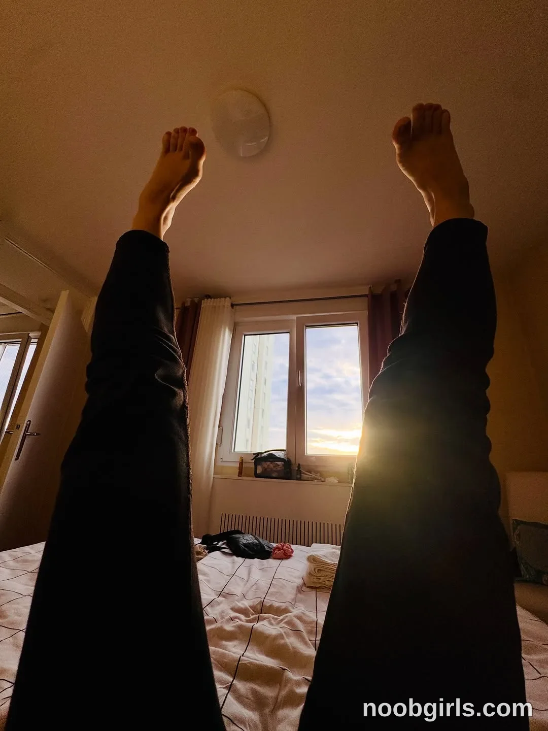 Pinkypupa-Love Lying on the bed with both legs raised upward wearing black trousers in bedroom
