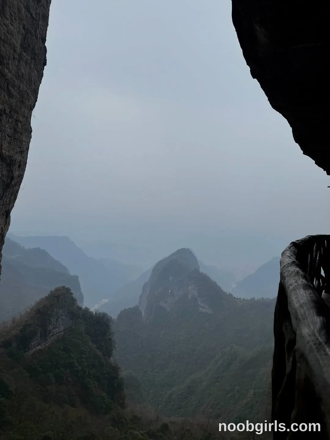 Elina no person visible in mountain cliffside walkway framed by rock overhang in Tianmenshan National Park