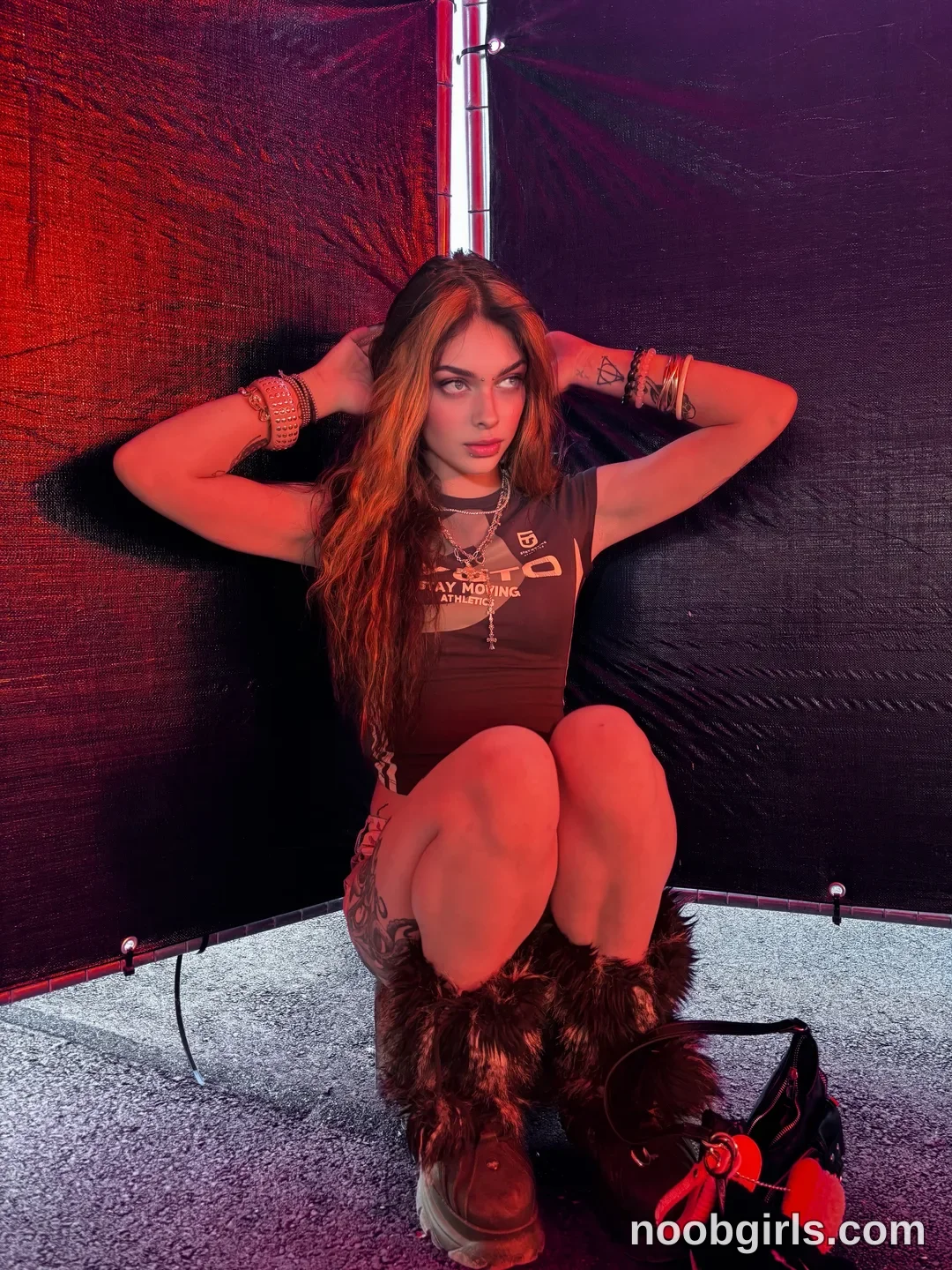 Queen Pinky crouching on the ground with knees bent toward her chest