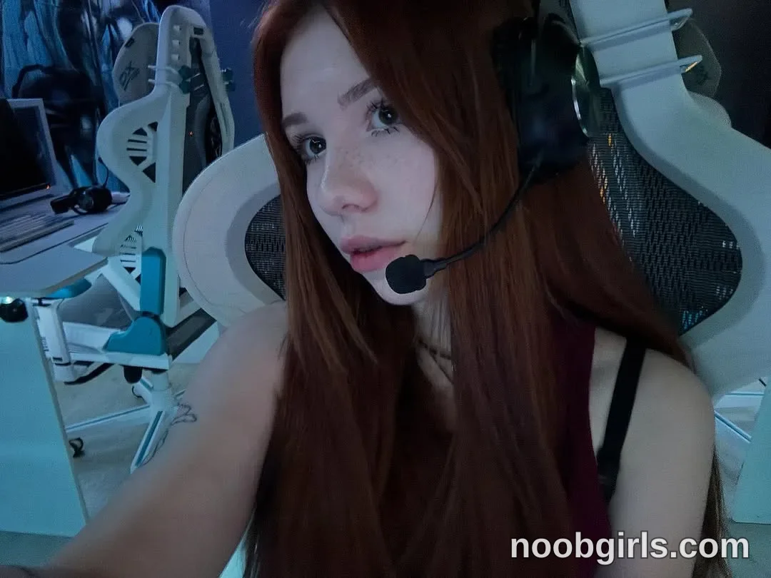 Jo Sitting in a chair with one arm extended toward the foreground