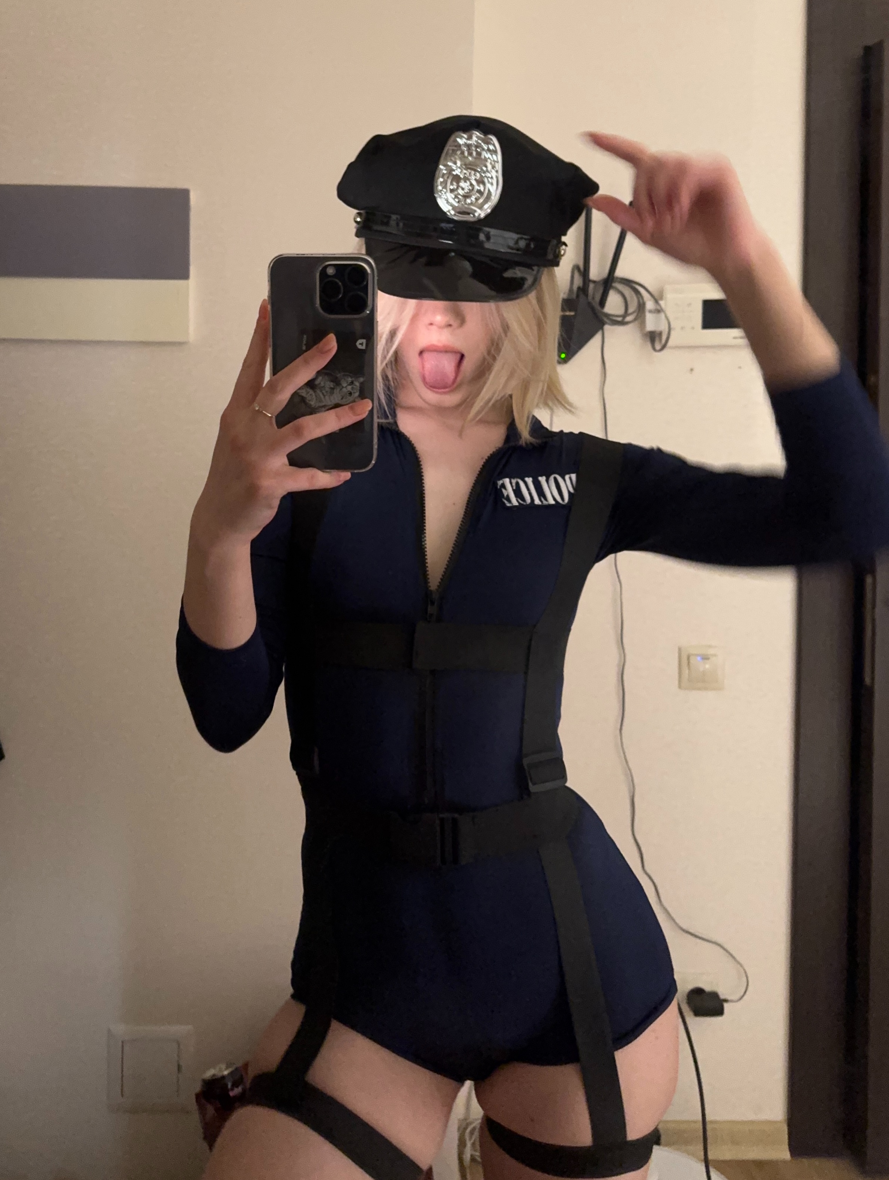 tollysage taking a mirror selfie wearing black police hat
