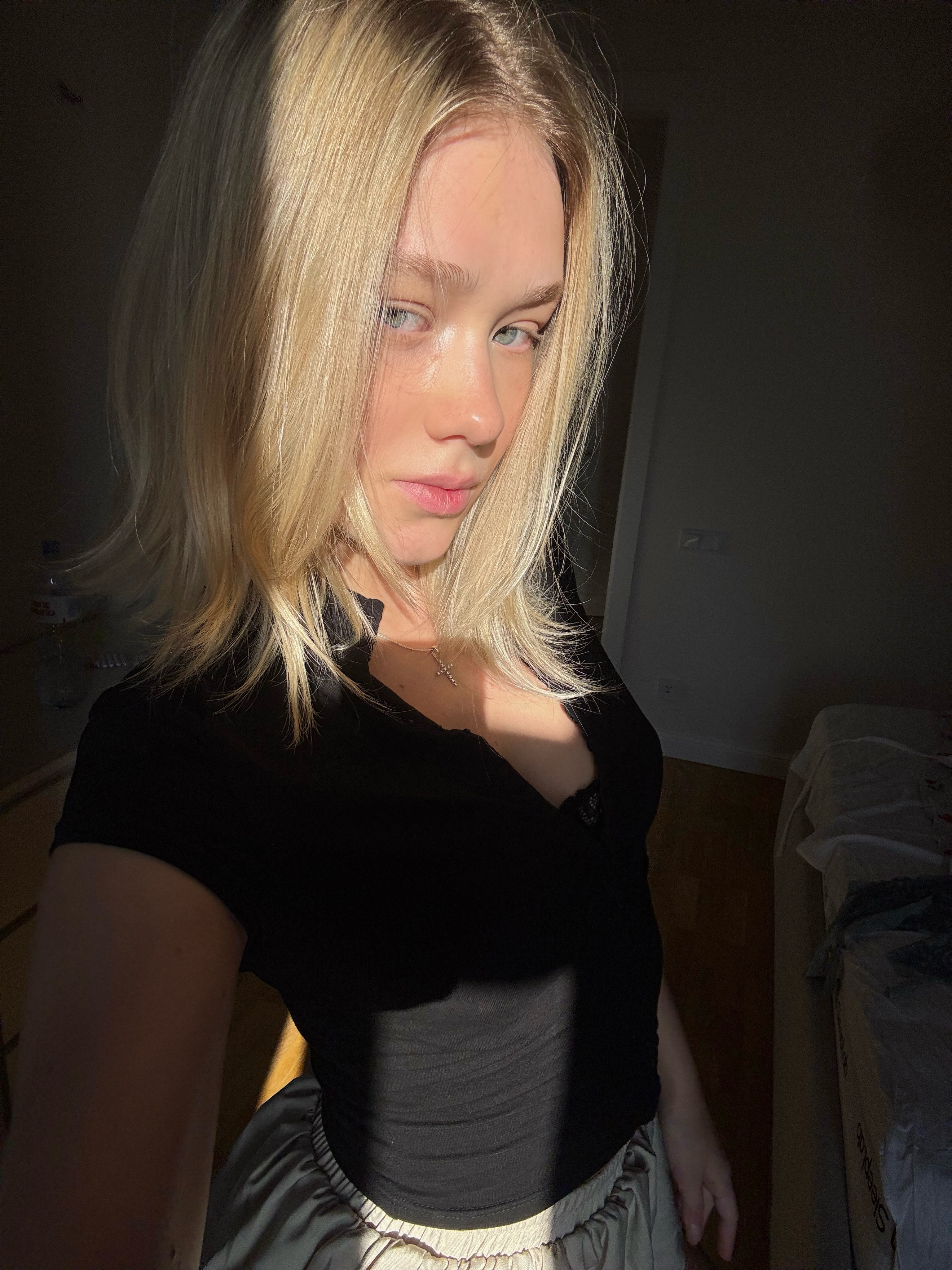 tollysage posing for portrait wearing black top in room