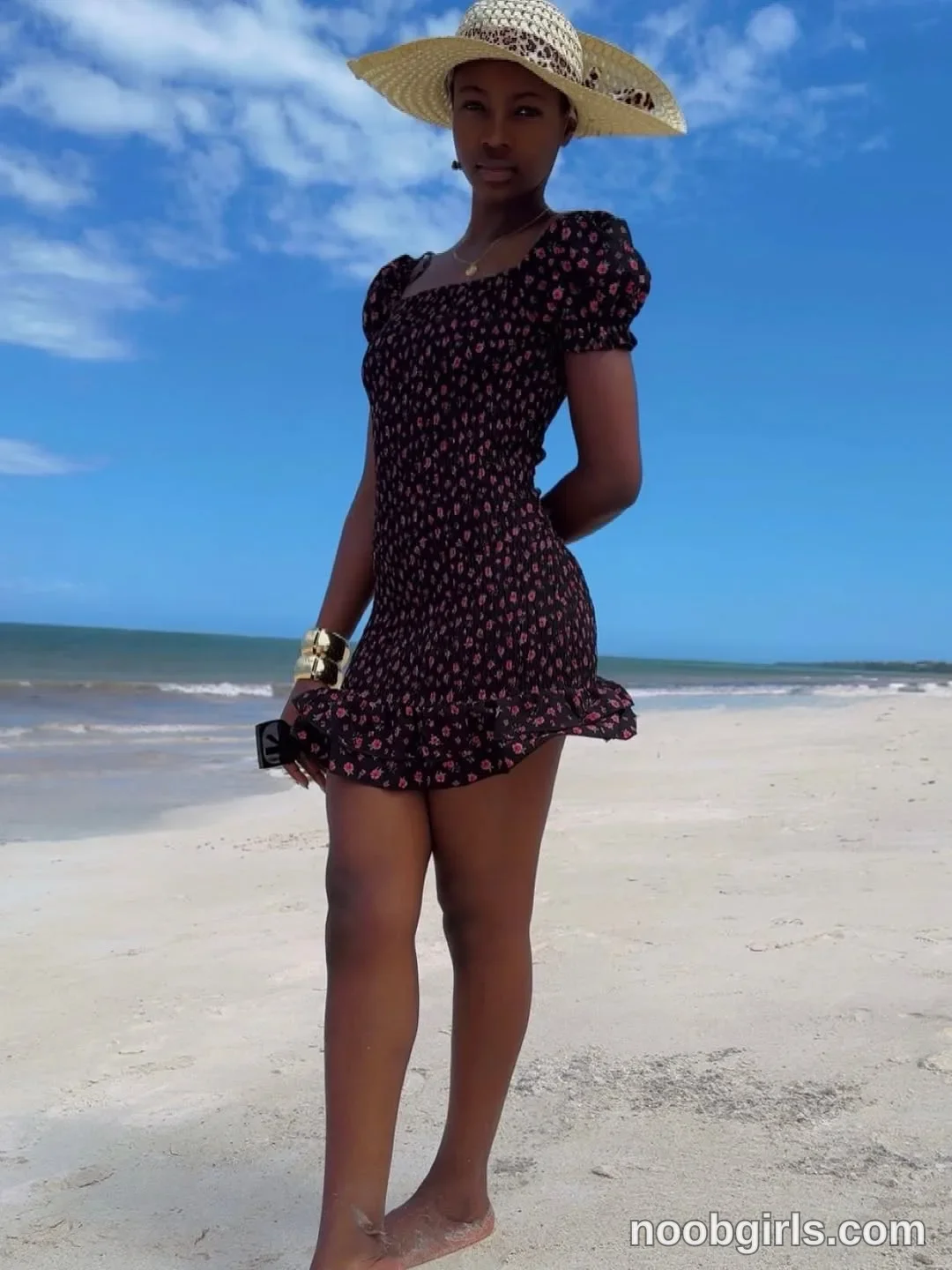 tootie03 Standing barefoot on the sand with one hand behind her back