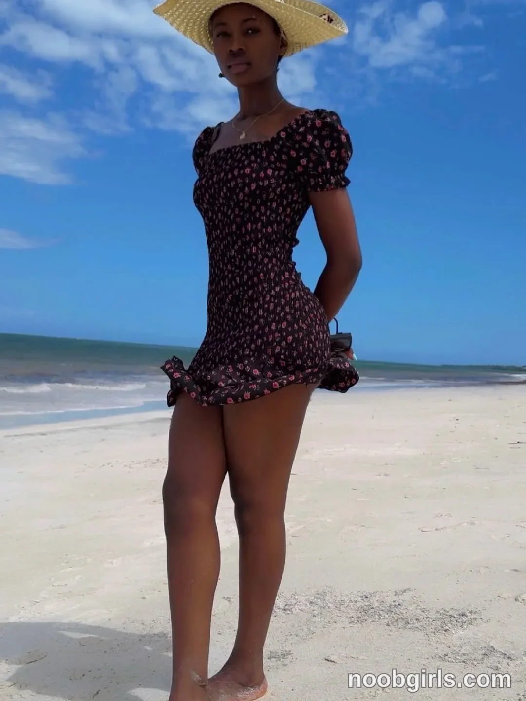 tootie03 Standing on the sand with her hands behind her back