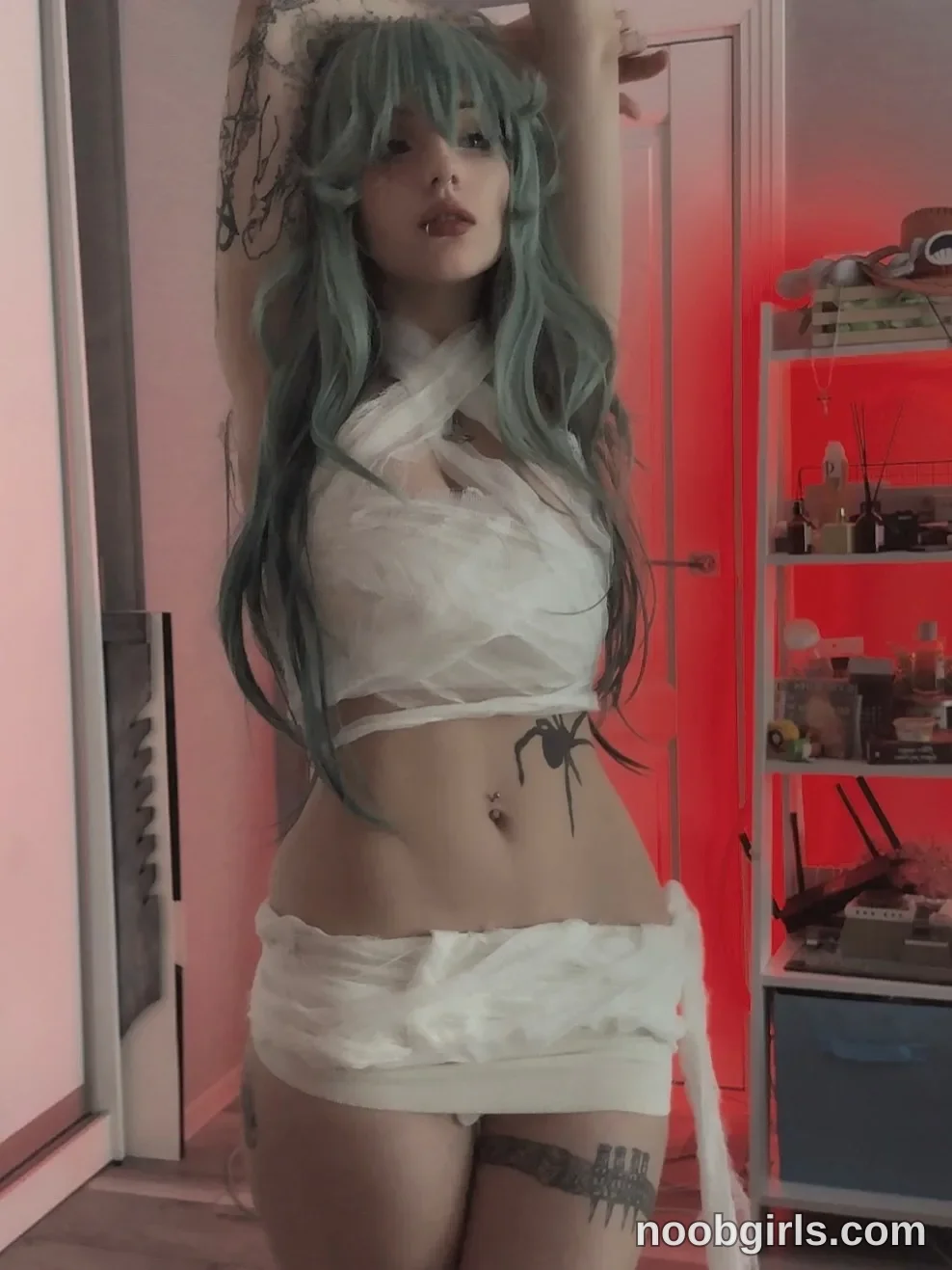 vivian_qwerty Standing facing the camera with both arms raised above her head