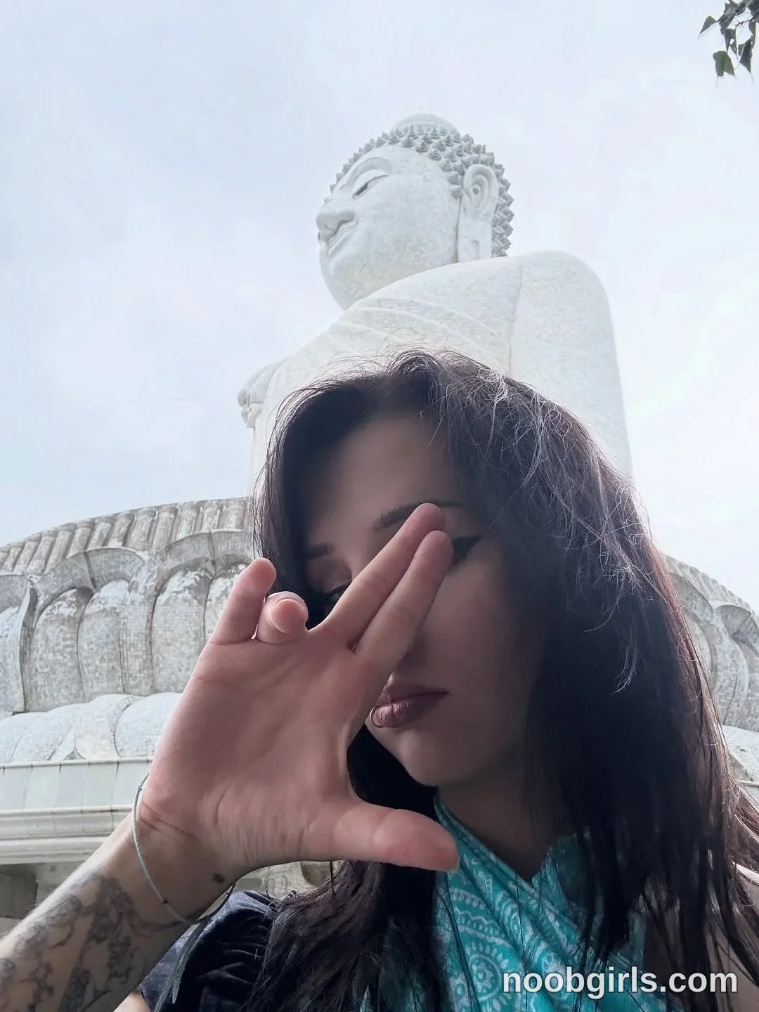 vivian_qwerty Holding one hand in front of her face wearing Black top