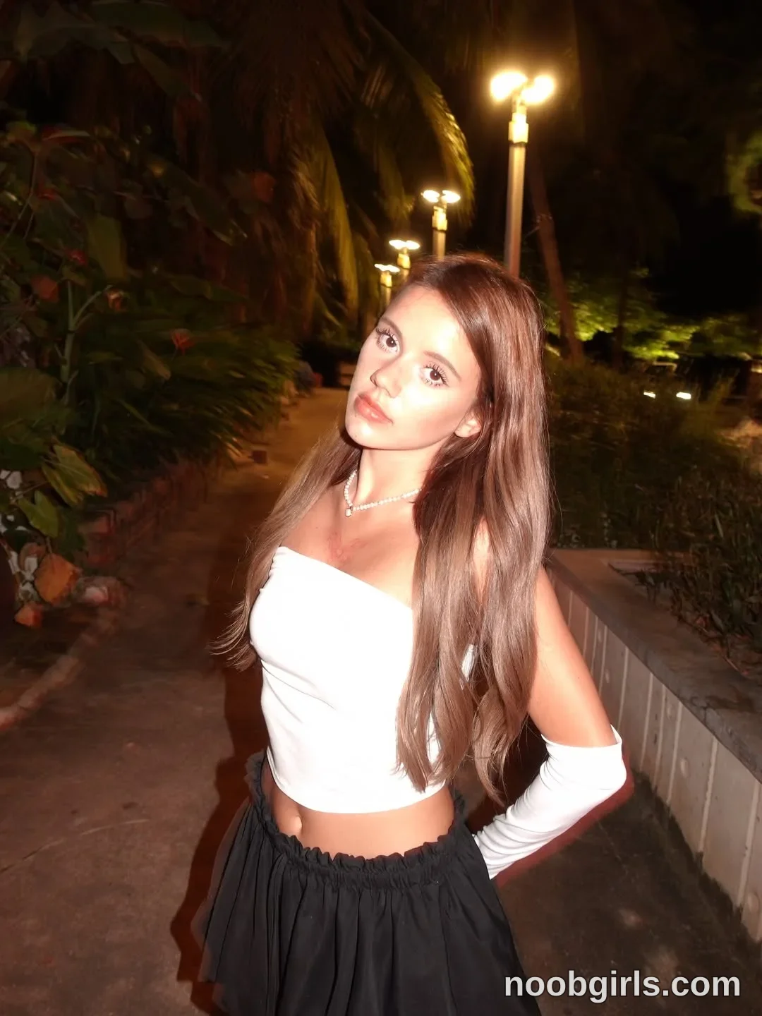 waki_lucky Standing facing the camera with her head tilted wearing White strapless cropped top