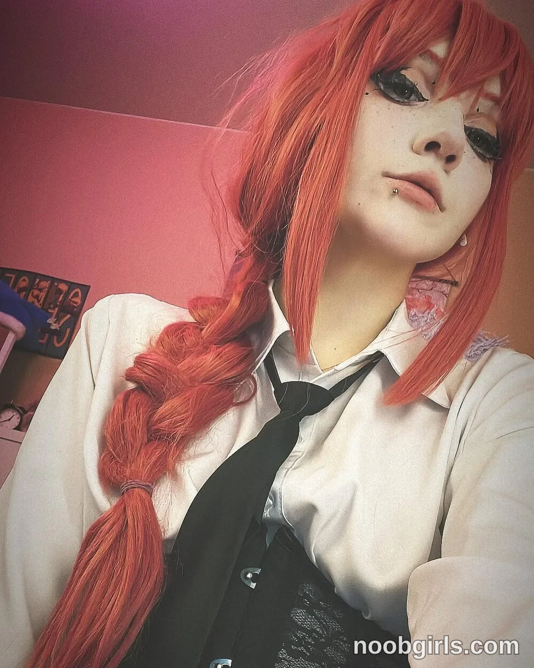 Lina Facing the camera with her head tilted wearing white collared shirt in a room